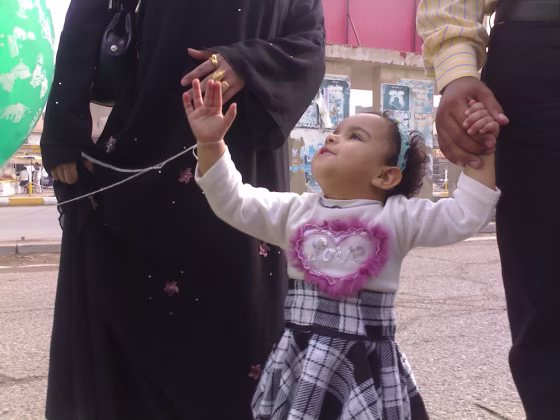 Nour, 2,&nbsp;leaves a Baghdad&nbsp;amusement park with her parents on Friday. Fear of bombs led Nour’s parents to cut short one of their daughter’s rare trips out of her home. 