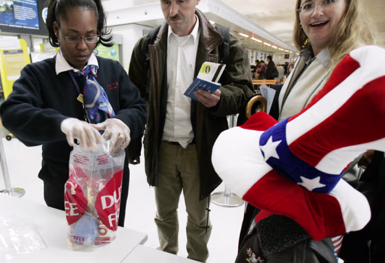 A security officer checks a plastic bag containing liquids bought in the duty-free zone at the Charles de Gaul airport in Roissy, north of Paris. 