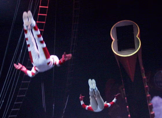 Husband and wife team Brian, left, and Tina Miser sail across the arena after being shot from their cannon as the opening act of the Ringling Bros. and Barnum & Bailey Circus.