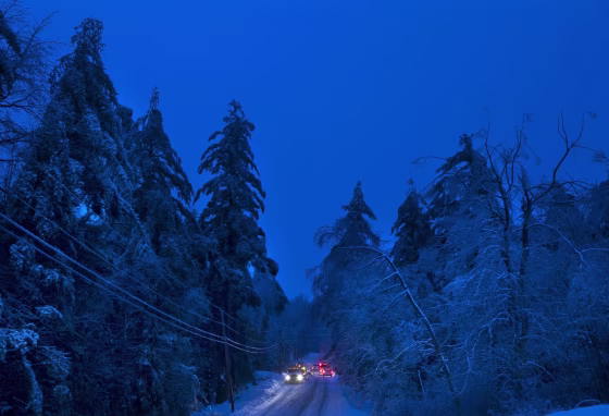 Image: Utility crews prepare to work on power lines at dusk, Thursday, Dec. 26, 2013, in Litchfield, Maine, where many have been without electricity since Monday's ice storm.
