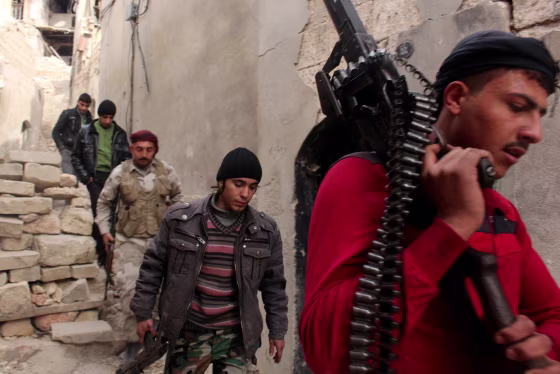 Image: Free Syrian Army fighters walk with their weapons