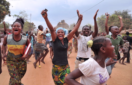 Residents of Bangui celebrate after former Seleka rebels were escorted out of Kasai military camp in Bangui to another camp outside the city on January 28, 2014. The UN Security Council will threaten sanctions on January 28 against the ringleaders of deadly turmoil in the Central African Republic and give a mandate to EU troops bolstering international forces there. The French-drafted resolution, expected to be adopted unanimously by the 15-nation council, also steps up pressure on interim President Catherine Samba Panza to restore order. AFP PHOTO / ISSOUF SANOGO
ISSOUF SANOGO/AFP/Getty Images