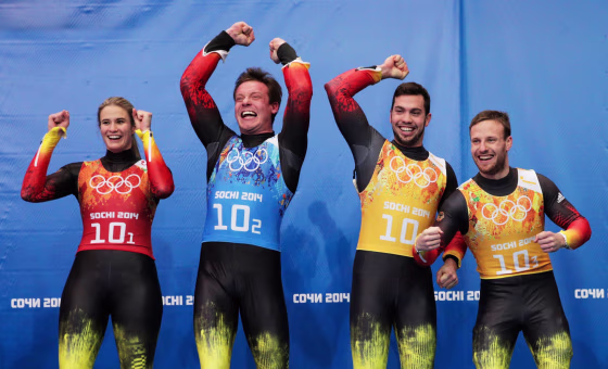 Gold medalists Natalie Geisenberger, Felix Loch, Tobias Wendl and Tobias Arlt (L-R) of Germany celebrate during the flower ceremony for the the Luge Relay on Day 6 of the Sochi 2014 Winter Olympics at Sliding Center Sanki on Feb. 13.