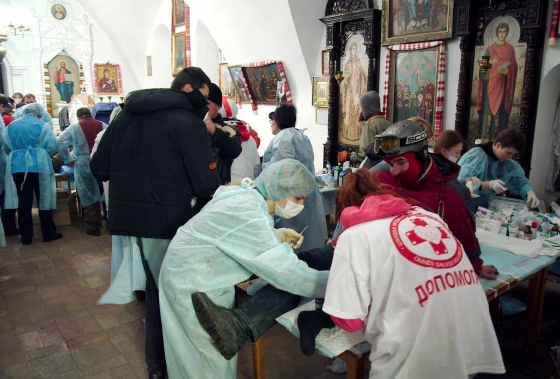 Image: Anti-government protesters receive medical treatment inside Mikhailovsky Zlatoverkhy Cathedral (St. Michael's golden-domed cathedral) in Kiev