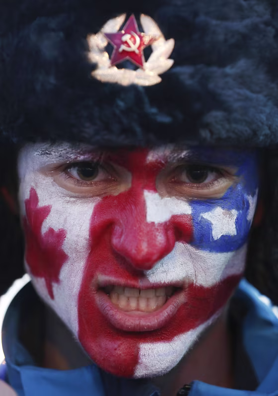 A hockey fan shows off the flags of Canada and the USA painted on his face before a semifinal men's ice hockey game between the two countries at the 2014 Winter Olympics on Friday.