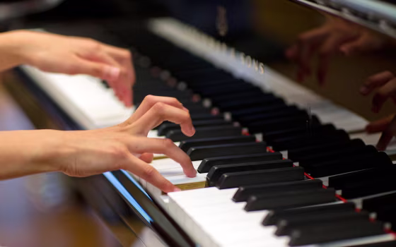 Image: Hands playing a piano