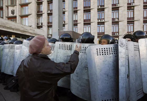 Image: A pro-Russian protester argues with riot policemen in Donetsk