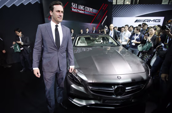Actor Jon Hamm poses for photographers next to the Mercedes-Benz S63 AMG Coupe after it was unveiled at the New York International Auto Show.