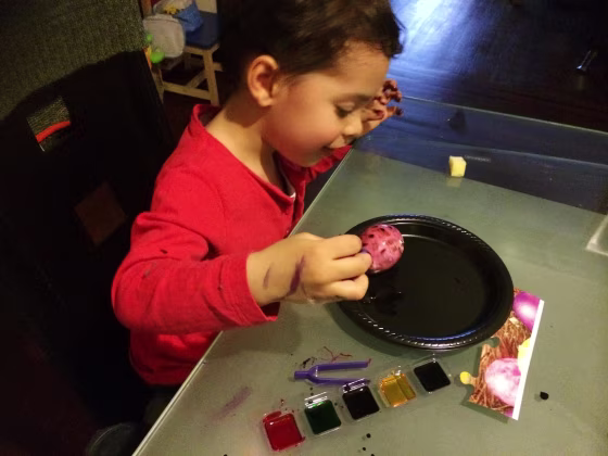 Image: Diana Limongi's son Enzo coloring eggs for the Easter holiday