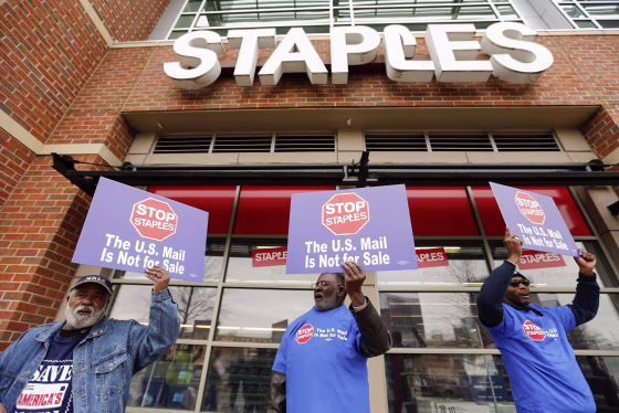 USPS workers picket outside Staples store