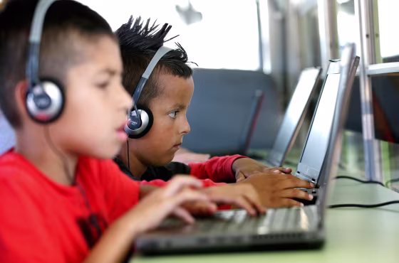 Children play on computers.