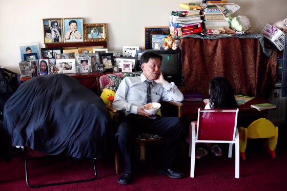 Alan Choy chats with his daughter Yvania, 8, about her day at their home in San Francisco, on June 17, 2014. The Choys, who receive Social Security Disability Insurance, are struggling financially.