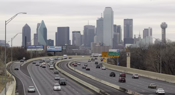 This Friday, Jan. 14, 2011 photo shows highway IH-30 traffic with the Dallas skyline in the background in Dallas.