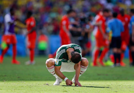 Mexico's Javier Hernandez punches the ground after the Netherlands defeated Mexico 2-1 to advance to the quarterfinals during the World Cup round of 16 soccer match between the Netherlands and Mexico at the Arena Castelao in Fortaleza, Brazil, Sunday, June 29, 2014.