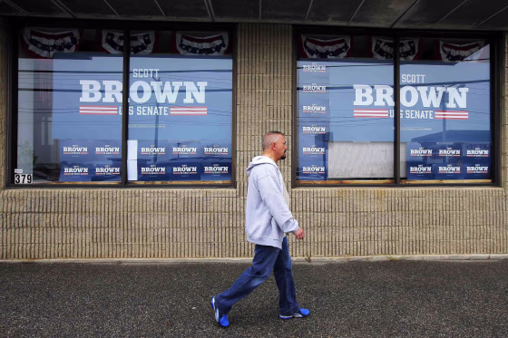 Image: A pedestrian walks past the campaign offices for Republican candidate for the U.S. Senate Scott Brown in Manchester