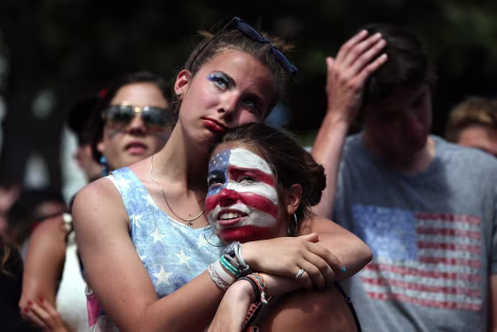 Image: Soccer fans Sofia Trogu and Anita Wray embrace as they watch the final minutes of a live simulcast of the FIFA World Cup quarter final match between USA and Belgium at the Civic Center plaza on July 1, in San Francisco, Calif.