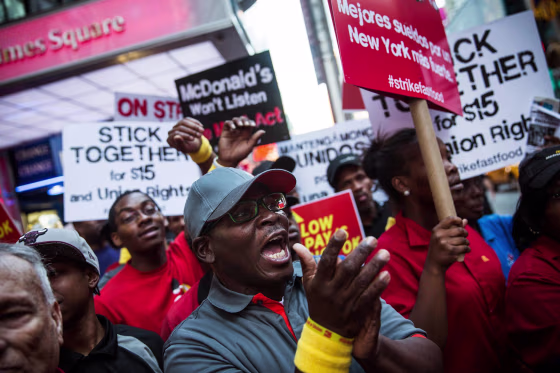 Image: Protesters demanding higher wages and unionization for fast food workers march near Times Square in New York City.