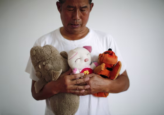 Image: Zhang Yongli, whose daughter Zhang Qi was onboard Malaysian Airlines Flight MH370 which disappeared on March 8, 2014 looks at his daughter's plush toys as he poses for a picture, during an interview with Reuters in Beijing