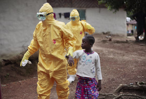 Nowa Paye, 9, is taken to an ambulance after showing signs of the Ebola infection in the village of Freeman Reserve, about 30 miles north of Monrovia, Liberia, on Sept. 30.