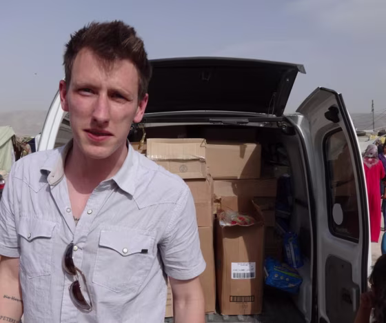 Image: Peter Kassig with a truck filled with supplies for Syrian refugees.