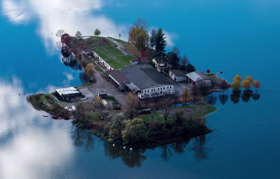 Image: Floodwaters caused by heavy rains surround a farm near the village of Magadino in Ticino, Switzerland