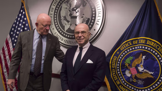 Image: US Director of National Intelligence James Clapper (L) greets French Interior Minister Bernard Cazeneuve