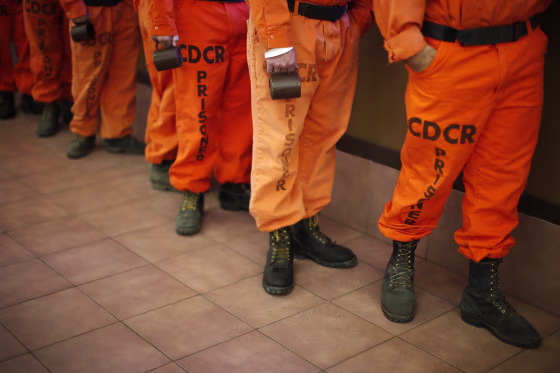 Image: Prison inmates wearing firefighting boots line up for breakfast at Oak Glen Conservation Fire Camp #35 in Yucaipa