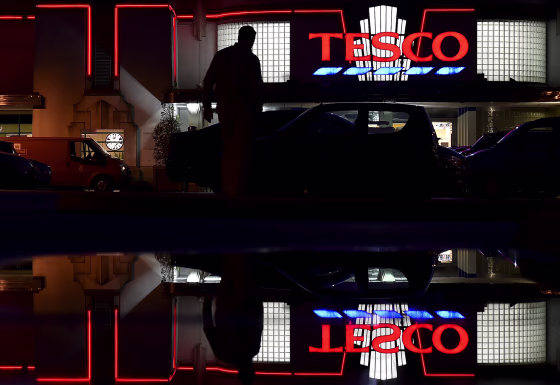 Image: File photo of a shopper entering a branch of Tesco supermarket in west London
