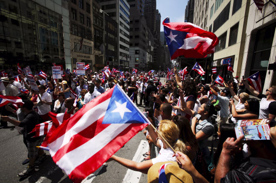 Image: People take part in the National Puerto Rican Day Parade on Fifth Avenue in Manhattan, New York