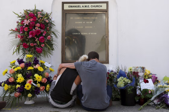 Image: Mourners Ashley Edge and Brad Hutchinson hold one another outside the Emanuel African Methodist Episcopal Church in Charleston