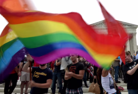 People wave a multicolored flag outside the Supreme Court in Washington, DC on June 26, 2015 after its historic decision on gay marriage. The US Supreme Court ruled Friday that gay marriage is a nationwide right, a landmark decision in one of the most keenly awaited announcements in decades and sparking scenes of jubilation. The nation's highest court, in a narrow 5-4 decision, said the US Constitution requires all states to carry out and recognize marriage between people of the same sex. AFP PHOTO/ MLADEN ANTONOVMLADEN ANTONOV/AFP/Getty Images