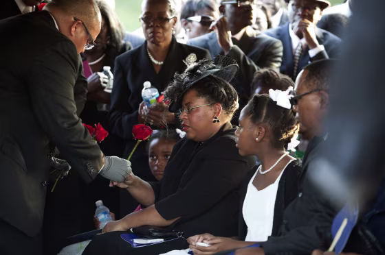 Image: Jennifer Pinckney accepts a rose at the burial of her husband Reverend Clementa Pinckney at the St James AME Church Cemetery in Marion, South Carolina