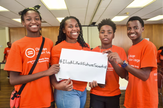 Chicago Urban League Stem Camp participants hold up a sign with the hashtag #ILookLikeAFutureScientist to promote diversity in the fields of science. The STEM camp brings students as young as fourth grade to Abbott facilities so they can see science and engineering in action.