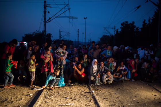 Image: Refugees wait near the railway station of Idomeni, northern Greece to cross the border and enter Macedonia