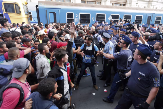 Image: Migrants face Hungarian police in the main Eastern Railway station in Budapest