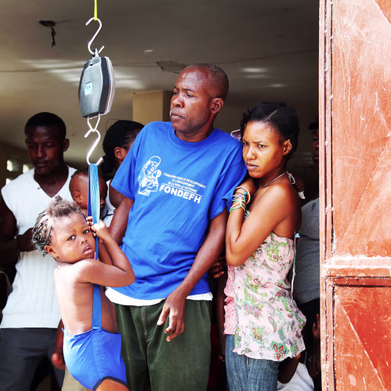 Image: Mother waits for her child to be weighed