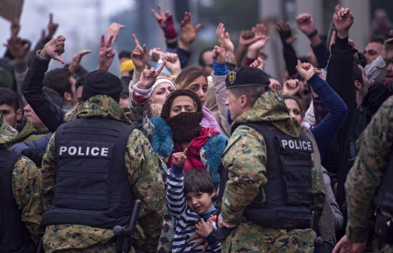 Image: Migrants who are not from Syria, Iraq or Afghanistan protest because they are not allowed to cross the border between Macedonia and Greece