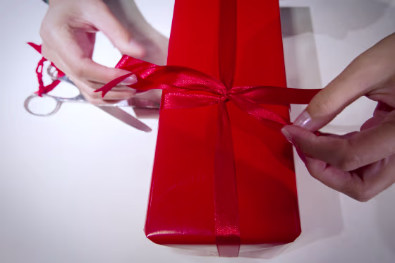 Image: A seller wraps a gift in a Parisian depa