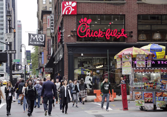 Image: People walk past a Chick-fil-A restaurant in New York City