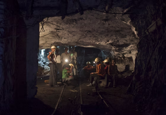 Image: File photo of miners resting inside an underground Barora coal mine at Dhanbad district