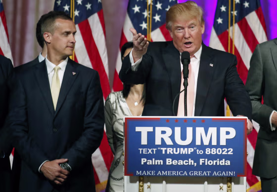 Image: Campaign manager Corey Lewandowski stands next to Donald Trump during a news conference in Palm Beach, Florida