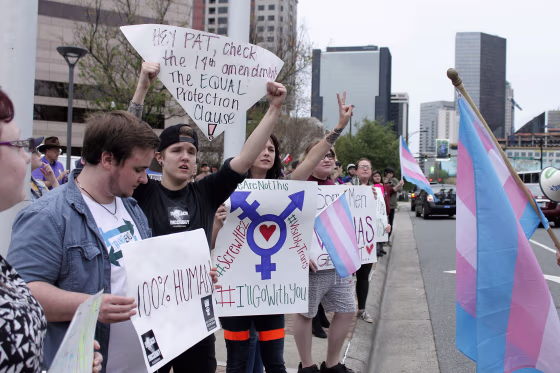 Image: Demonstrators protesting passage of legislation limiting bathroom access for transgender people stand in Charlotte, N.C.