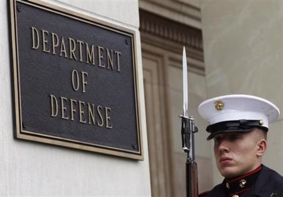 A U.S. Marine, who is part of a military honor guard, takes his position before a welcoming ceremony for German Defense Minister de Maiziere at the Pentagon in Washington