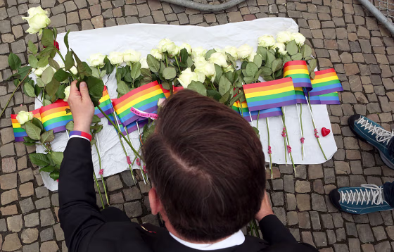 A visitor places flowers at a makeshift memorial during a vigil for victims of a shooting at a gay nightclub in Orlando, Florida the previous day, in front of the United States embassy on June 13, 2016 in Berlin, Germany.