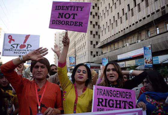 Transgender people in Pakistan carry placards as they rally to mark World Aids Day in Karachi on November 30, 2013.