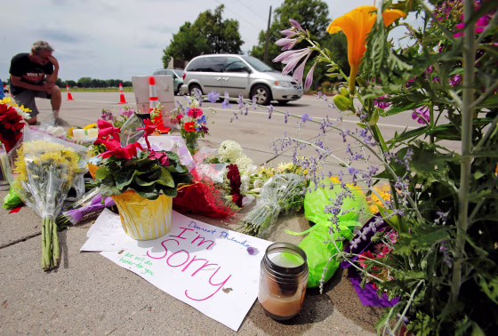 Image: Man kneels at shooting site of Philando Castile in Minnesota