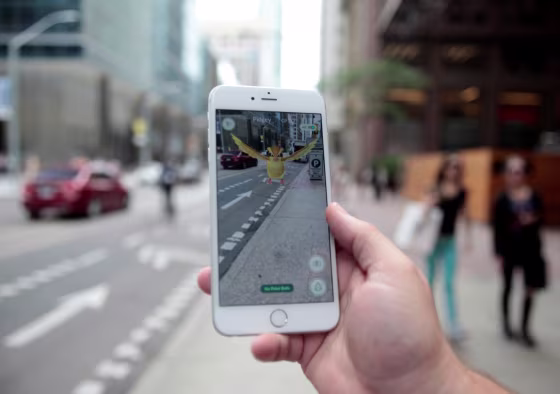 Image: Photo illustration of a \"Pidgey\" Pokemon seen on the screen of the Pokemon Go mobile app