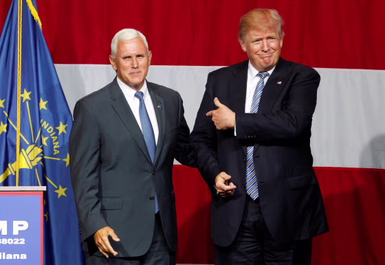 Image: Republican presidential candidate Donald Trump and Indiana Governor Mike Pence wave to the crowd before addressing the crowd during a campaign stop at the Grand Park Events Center in Westfield