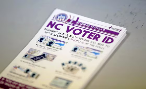 A pile of government pamphlets explaining North Carolina's controversial "Voter ID" law sits on table at a polling station as the law goes into effect for the state's presidential primary in Charlotte, North Carolina, U.S. on March 15.