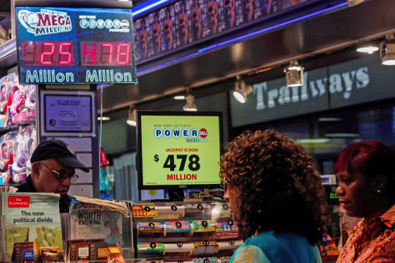 Image: Customers purchase Powerball lottery tickets in New York, U.S.